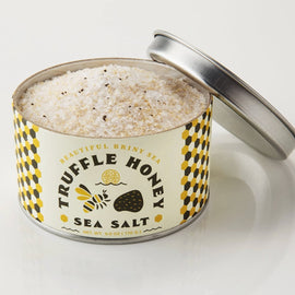 Tin of Beautiful Briny Sea Truffle Honey Sea Salt with visible coarse salt and truffle flecks.