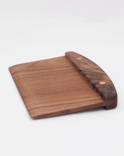 Handcrafted wooden walnut bench scraper with pinned handle on white background.
