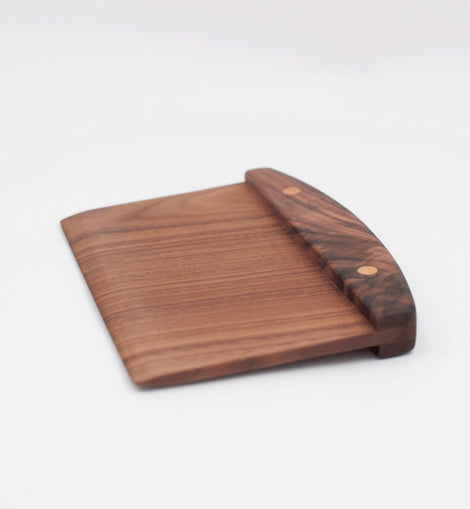 Handcrafted wooden walnut bench scraper with pinned handle on white background.
