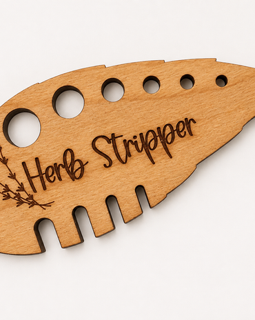 A light natural wood herb stripper tool with laser-engraved text and a small leaf illustration, shown on a plain white background.