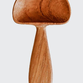 Hand-carved wooden mushroom scoop with rounded cap and smooth handle, photographed on a white background.