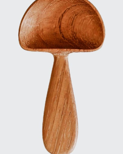 Hand-carved wooden mushroom scoop with rounded cap and smooth handle, photographed on a white background.