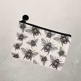 small zipper pouch with black bee print design on fabric
