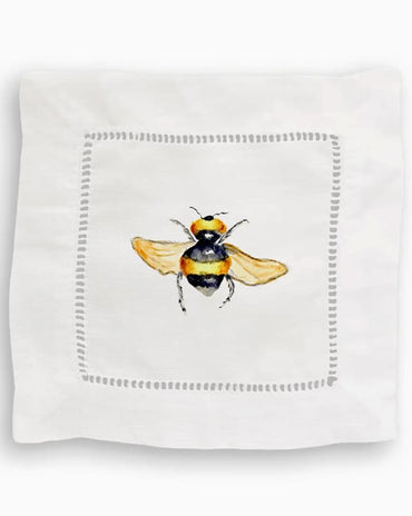 White linen cocktail napkin featuring a watercolor bumblebee illustration and decorative border, sold in a set of four.