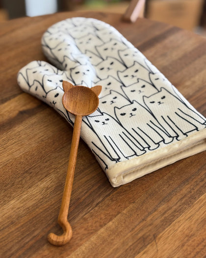 cat print oven mitt paired with wooden spoon featuring cat-shaped handle