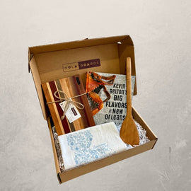 New Orleans Cooking Gift Box with Petit Fromage Board, Louisiana Tea Towel, 12" Roux Spoon, and Kevin Belton’s Big Flavors of New Orleans Cookbook.