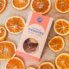 box of dehydrated orange slices for cocktail garnish surrounded by dried citrus slices