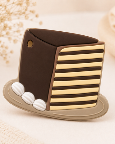 Decorative item resembling a top hat with striped design on a textured beige background