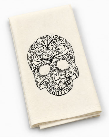 Cream kitchen tea towel featuring an intricate black embroidered sugar skull design.