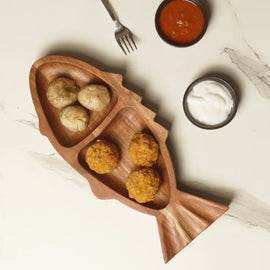 Handcrafted wooden fish-shaped tray with two serving sections and natural wood finish