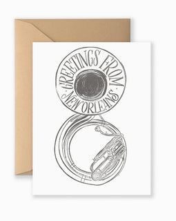 Greeting card with bold, vintage-style “Greetings from New Orleans” text and postcard design, shown with kraft envelope

