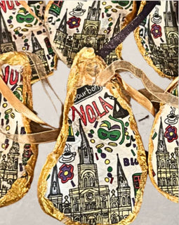 handpainted oyster shell ornament with New Orleans illustrations and gold edging