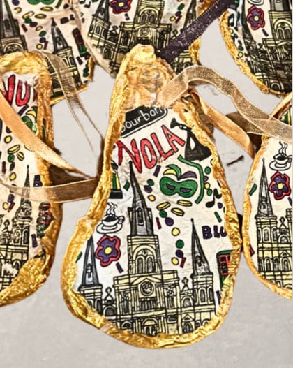 handpainted oyster shell ornament with New Orleans illustrations and gold edging