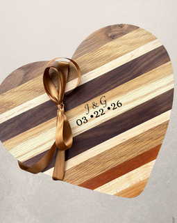 Engraved Heart shaped wooden cutting board made from mixed hardwoods with natural grain patterns, perfect for charcuterie and serving