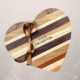 Engraved Heart shaped wooden cutting board made from mixed hardwoods with natural grain patterns, perfect for charcuterie and serving