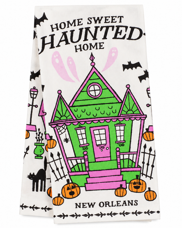 Home Sweet Haunted Home New Orleans Halloween kitchen towel with colorful haunted house, bats, ghosts, pumpkins, and black cat.