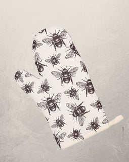 white oven mitt with black honey bee pattern