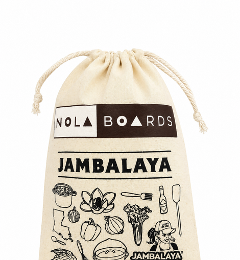 A beige canvas drawstring pouch featuring black printed graphics and text, including 'NOLA BOARDS', 'JAMBALAYA', and food-themed illustrations, on a white background.