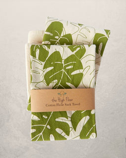 monstera leaf tea towel with green botanical print on natural cotton, modern kitchen towel made from recycled Turkish cotton