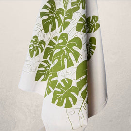 monstera leaf tea towel with green botanical print on natural cotton, modern kitchen towel made from recycled Turkish cotton