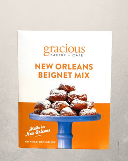 box of Gracious Bakery New Orleans beignet mix with powdered sugar beignets pictured