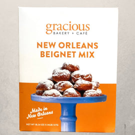 box of Gracious Bakery New Orleans beignet mix with powdered sugar beignets pictured