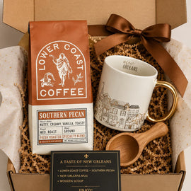 Gift set with Lower Coast Coffee, mug, wooden scoop, and New Orleans-themed items in a box.
