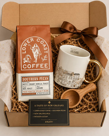 Gift set with Lower Coast Coffee, mug, wooden scoop, and New Orleans-themed items in a box.