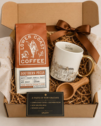 Gift set with Lower Coast Coffee, mug, wooden scoop, and New Orleans-themed items in a box.