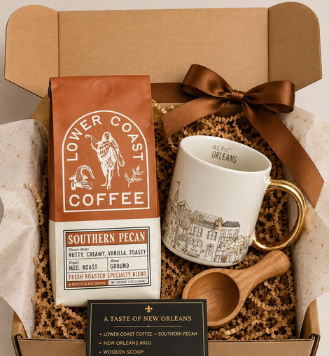 Gift set with Lower Coast Coffee, mug, wooden scoop, and New Orleans-themed items in a box.