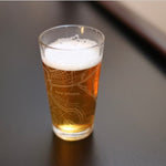 etched New Orleans map pint glass filled with beer, modern Louisiana souvenir glass
