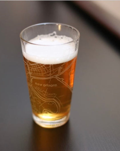 etched New Orleans map pint glass filled with beer, modern Louisiana souvenir glass
