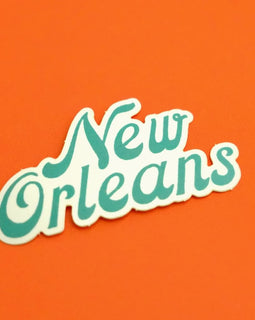retro style New Orleans script vinyl sticker on orange background