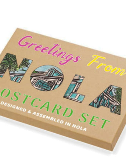 Box of 'Greetings From NOLA Postcard Set' with colorful text and images on a white background