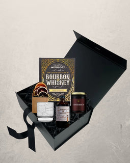 Old Fashioned groomsman gift box with bourbon cocktail kit, mixology book, cherries, citrus garnish, and New Orleans whiskey glass