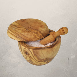olive wood salt cellar with lid and matching scoop filled with salt
