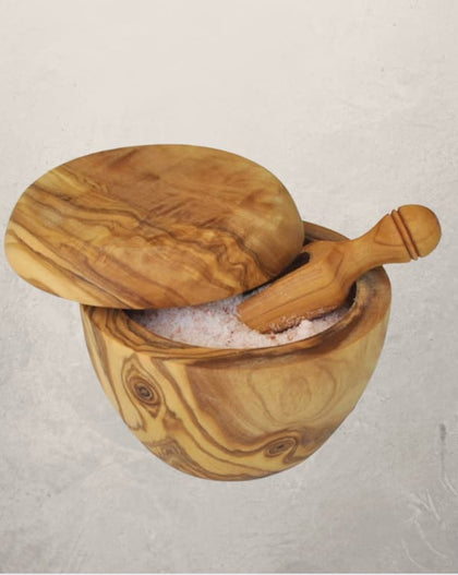 olive wood salt cellar with lid and matching scoop filled with salt