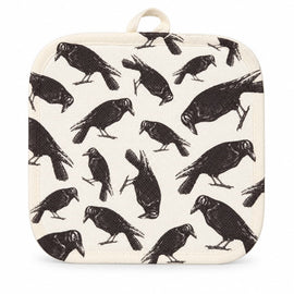 Cream pot holder with vintage-style black raven print displayed on a kitchen countertop.