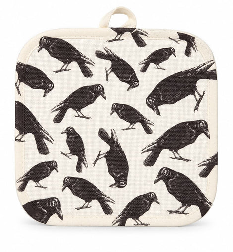 Cream pot holder with vintage-style black raven print displayed on a kitchen countertop.