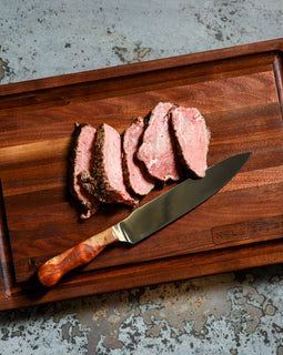 Sac-A-Lait cutting board with cut meat and knife