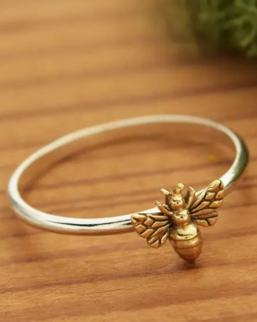 Sterling silver ring featuring a small detailed bronze honeybee on a polished silver band.