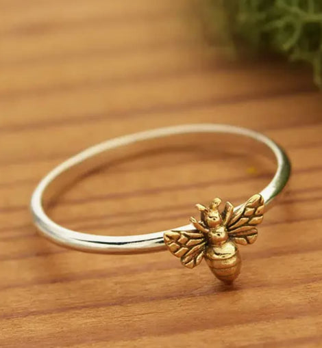 Sterling silver ring featuring a small detailed bronze honeybee on a polished silver band.