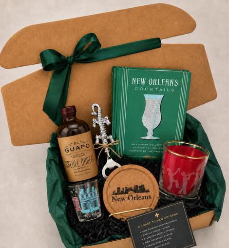 Gift set with New Orleans-themed items including a bottle, book, and coasters.