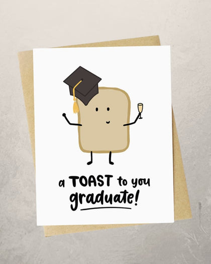 graduation card with toast character wearing cap and holding champagne