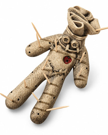Weathered voodoo doll toothpick holder with button details, red heart accent, and wooden toothpicks.