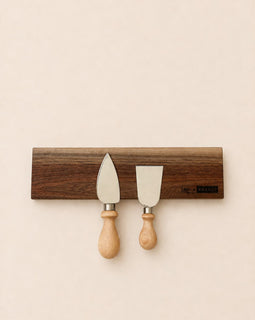 walnut magnetic knife holder with knives mounted on wall