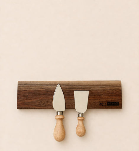 walnut magnetic knife holder with knives mounted on wall