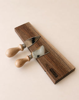 walnut magnetic knife holder with knives mounted on wall