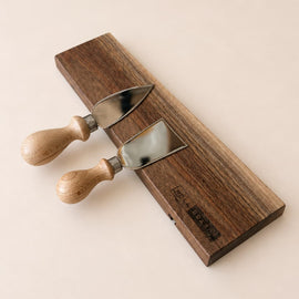 walnut magnetic knife holder with knives mounted on wall