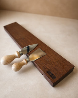 18-inch natural edge walnut magnetic knife holder with knives on a clean neutral background
